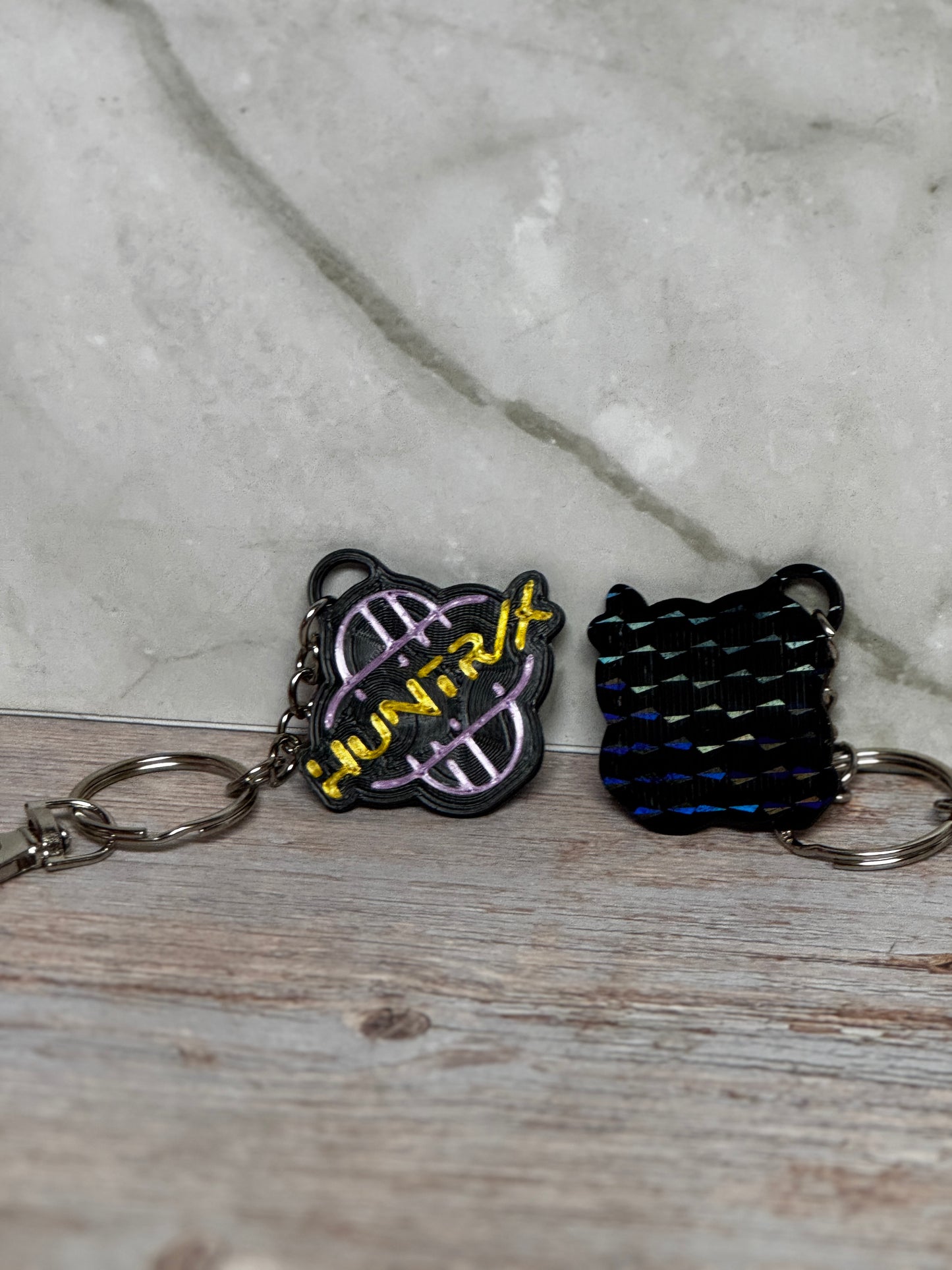 HUNTRX Acrylic Keychain – Purple & Gold Logo with Holographic Back